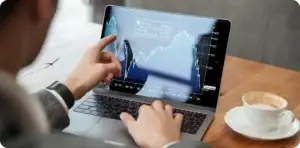 Laptop and tablet displaying financial market charts