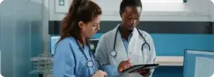Healthcare professionals reviewing information on a tablet