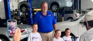 Couple speaking with a salesperson at an RV dealership