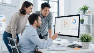 Marketing team reviewing local search visibility, map data, and performance analytics on a desktop computer